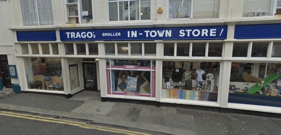 Trago's Smaller In-Town Store in Falmouth, featuring shop windows displaying various items for sale.