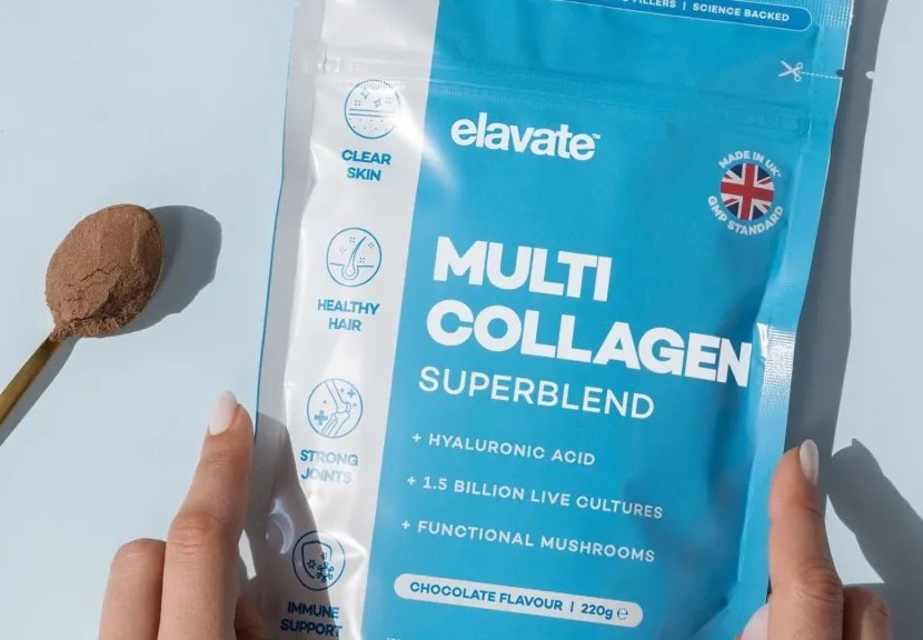 A spoon of chocolate-flavored Elevate Multi Collagen Superblend next to its packaging.