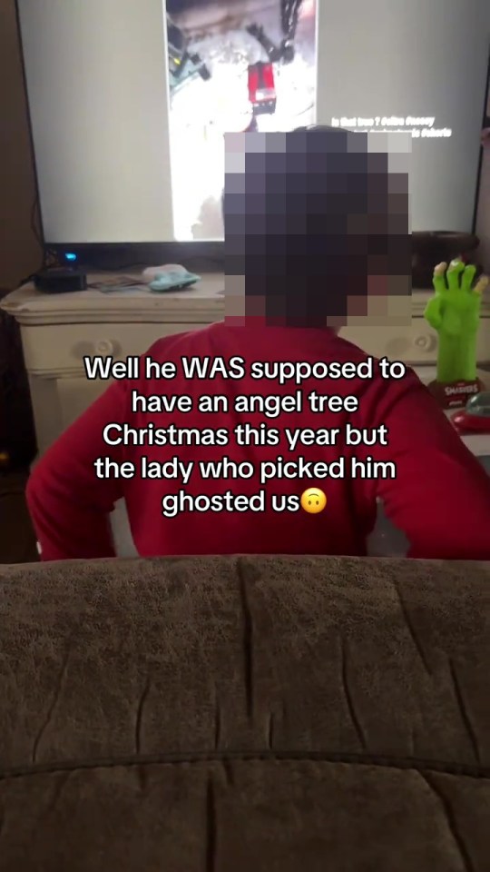 A child in a red shirt watching a screen with a message about being ghosted by an angel tree sponsor.