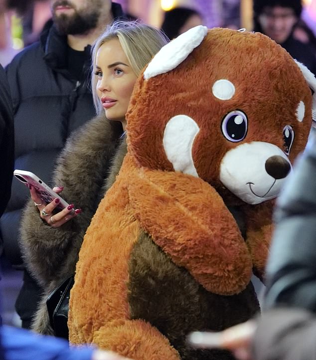 Olivia looked glamorous as she wrapped up warm in a brown fur coat which she teamed with a pair of distressed jeans and Ugg boots