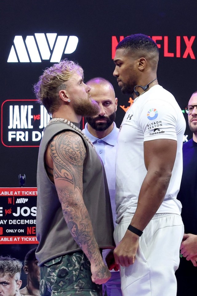 Jake Paul and Anthony Joshua face off during a press conference.