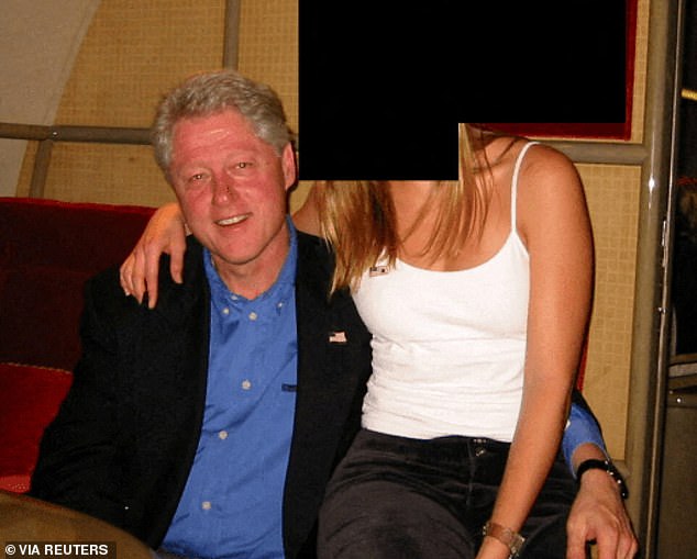 Bill Clinton seen with a redacted woman on his lap