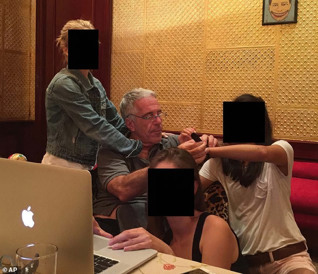 In images from the previous files release on Thursday, Epstein was seen surrounded by a group of women as he sat behind a desk