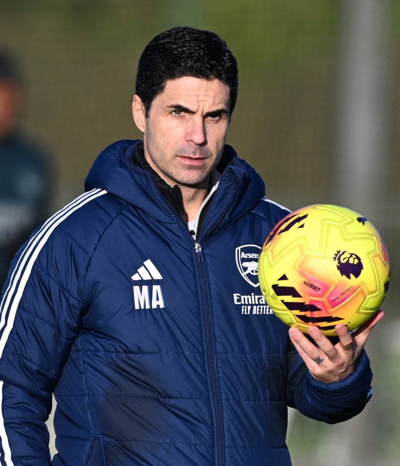 Mikel Arteta holding a football during an Arsenal training session.