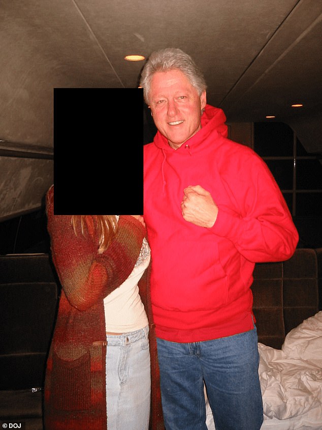 Clinton is pictured with an unknown woman in what appears to be a bedroom