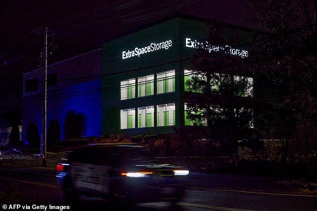 A Salem Police Department cruiser drives past the storage facility where the suspect behind the mass shooting at Brown University was found dead