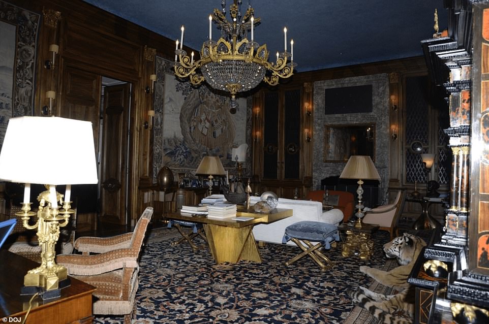 His living room appeared to have massive floor to ceiling art work and a chandelier