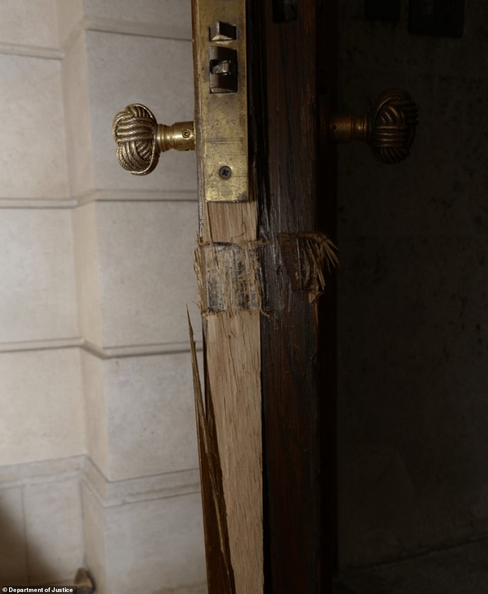 A door in Epstein's home was photographed with sever damage on the bottom half