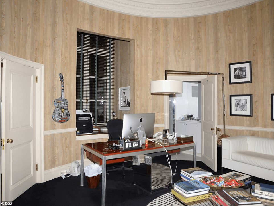 His office had several pictures hung on the walls as well as a guitar