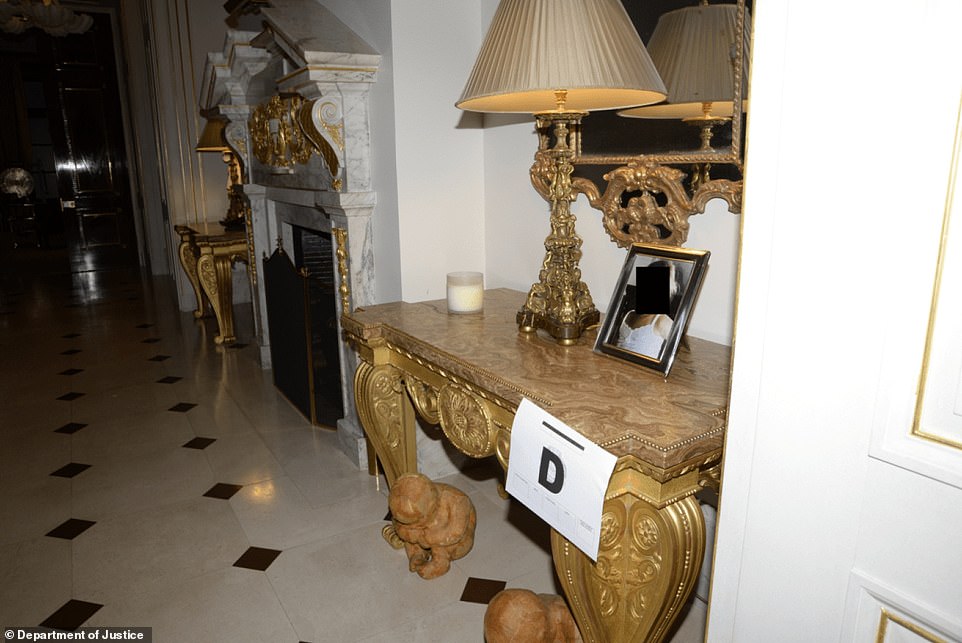 An image of a redacted girl was framed on a golden table