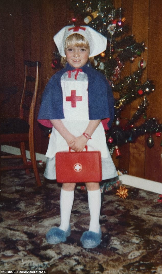 Sandie aged seven in a nurse's fancy dress costume that her parents gave her