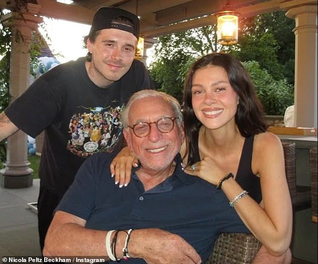 Brooklyn has joined her on the trip, appearing to suggest he could be spending the festive period with his in-laws amid his family feud (pictured in July with her father Nelson)