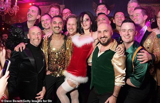 The Nonmonogamummy star danced up a storm and cheered with delight as the London Gay Men's Chorus also arrived to serenade the bash