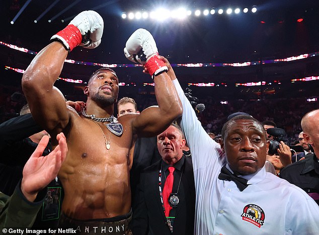 The referee raises Joshua's arm at the end of the heavyweight bout in Miami on Friday night