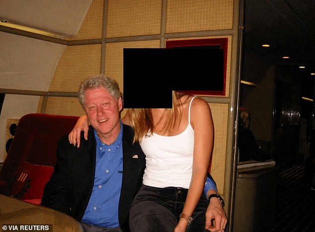 Clinton grinned with a redacted woman perched right next to him