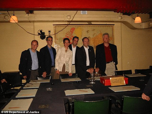 In another photo from the files, the former president posed at a desk in Winston Churchills War Rooms with Ghislaine Maxwell and Kevin Spacey