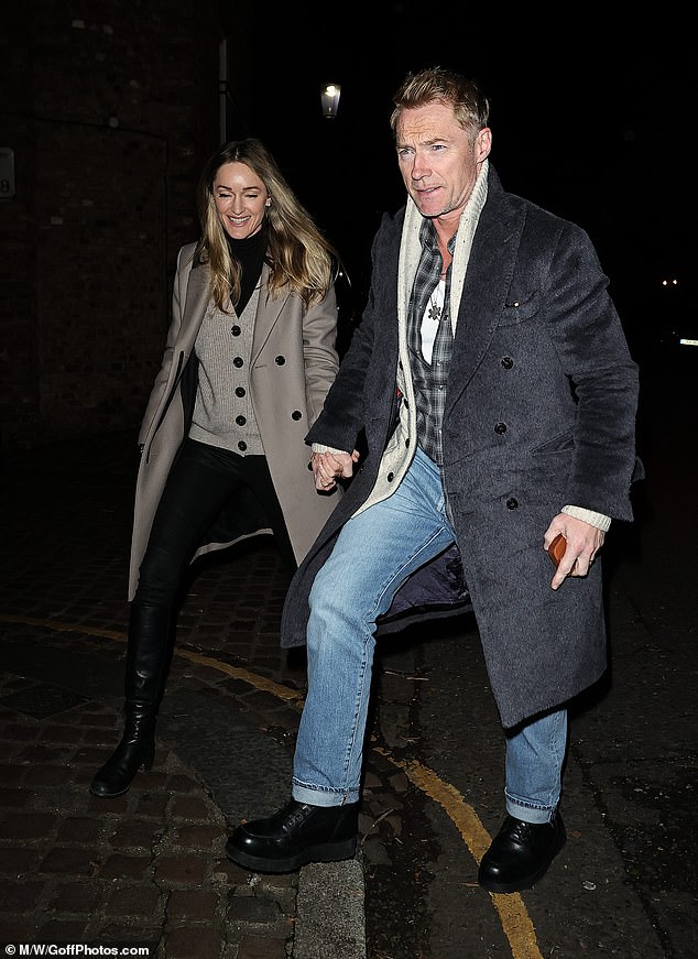 Ronan kept it casual in a plaid grey shirt, jeans, and grey winter coat
