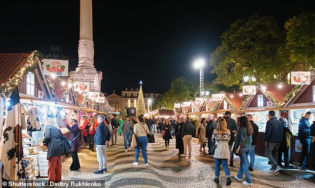 Lisbon may not be your classic Christmas destination...but it has plenty to charm festive visitors (Pictured Rossio Square's yuletide market)