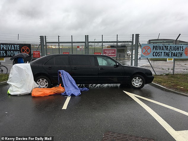A limousine is trashed in protest against increased flight numbers at Farnborough Airport