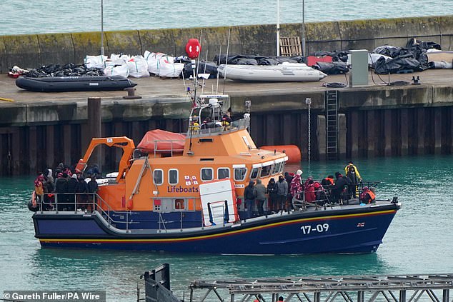 Pictured: A group of migrants bein brought onto the Border Force compound in Dover, Kent, today