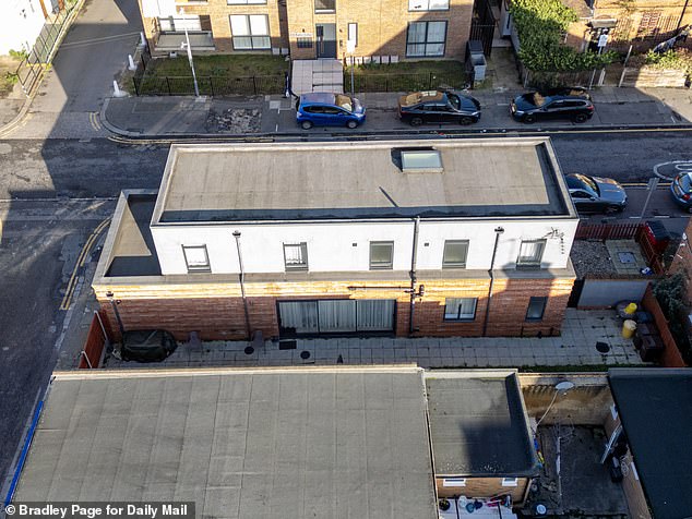 An aerial view shows the slim design of the house and surrounding patio