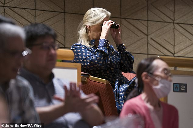 Sophie watched on from the crowd using a pair of binoculars