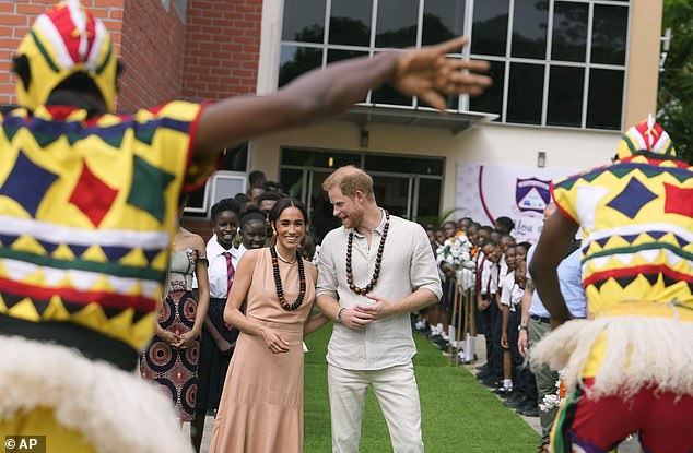 Meghan and Harry watch dancers at the Lightway Academy in Abuja, Nigeria, in May 2024