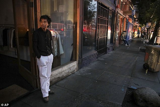 Ryan Sicat, store manager of Industry of All Nations, stands outside the store amid the major power outage impacting 30 percent of San Francisco