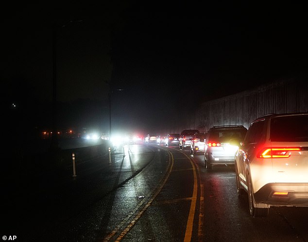 Vehicles move slowly in traffic as power outages darken the San Francisco streets