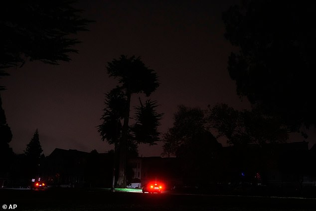 The taillights from a vehicle are shown as power outages darken the streets in San Francisco