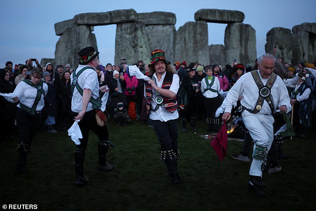 Folk dancers were also pictured performing this morning in traditional outfits