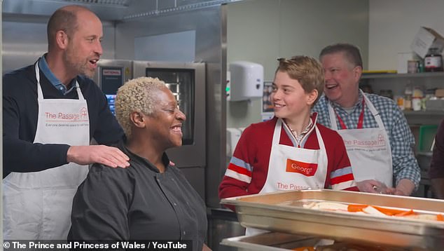 Prince George smiles as she shares a laugh with charity staff and volunteers