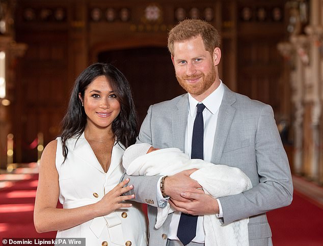 The Duke and Duchess of Sussex with their baby son, Prince Archie, during a photocall at St George's Hall at Windsor Castle after his birth