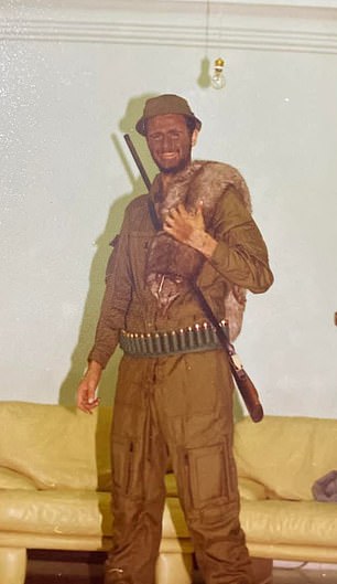 One picture shows him in a khaki hunter costume with a gun and fur accessory