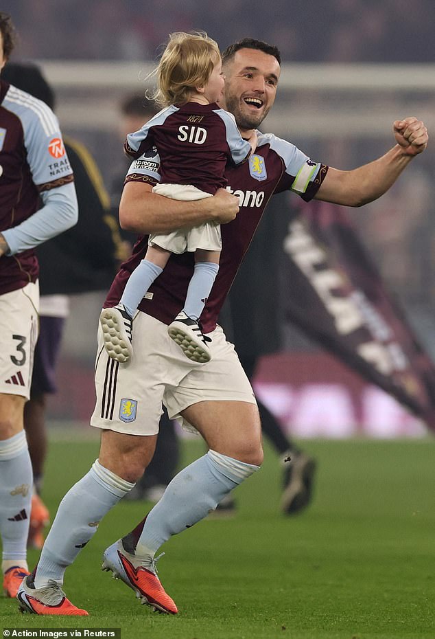 The tot was carried onto the pitch by Aston Villa player John McGinn...