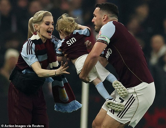 ...before being passed to his mother and watching the game from the sidelines