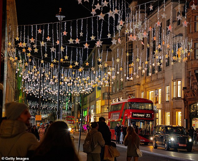 London is decorated with star-shaped Christmas lights and festive holiday illuminations against the night sky