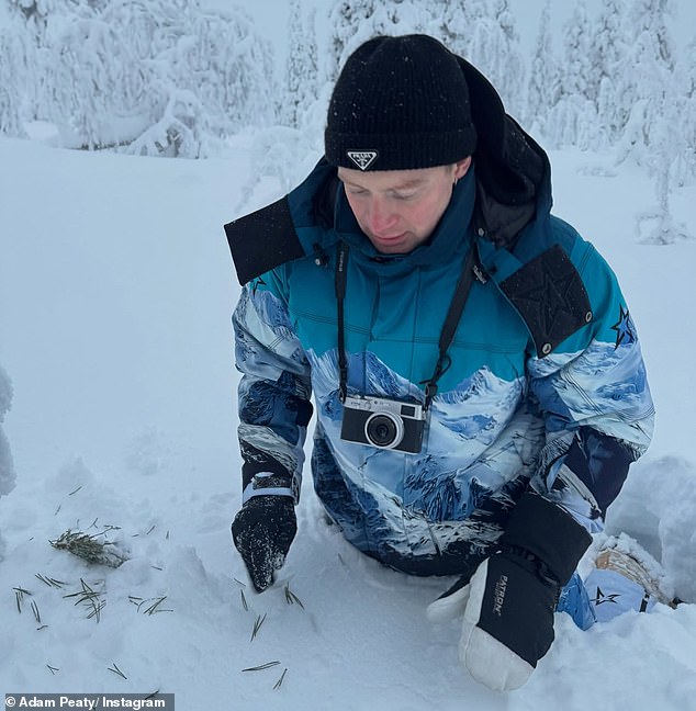 Among a handful of holiday snaps, Adam was pictured waist deep in heavy snow while out with his loved ones and showing his designer beanie