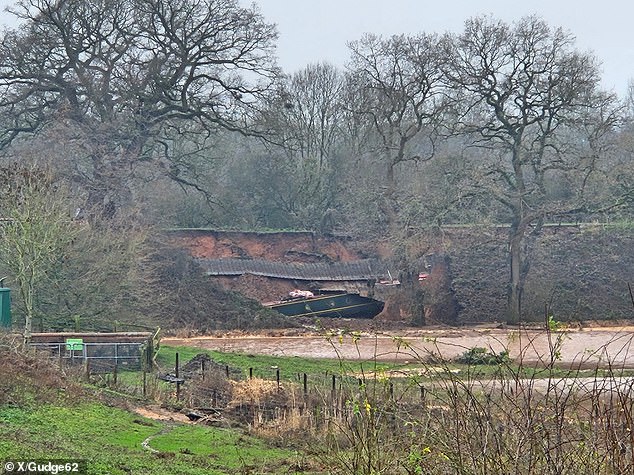 Firefighters rushed to rescue around 10 crew members from canal boats as the sinkhole opened up