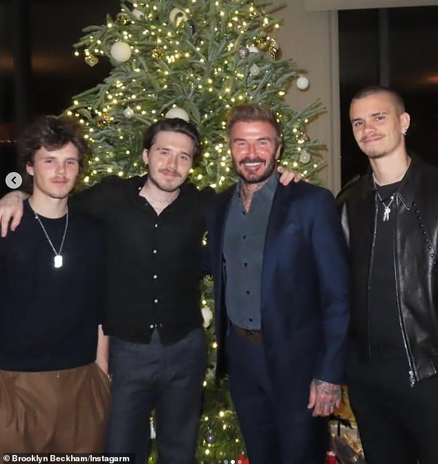 Brooklyn is pictured in happier times with his father and brother last year