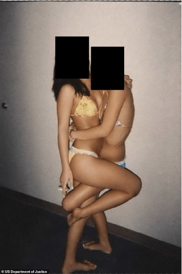 Two unidentified young women pose in bikinis, with one smoking a cigarette