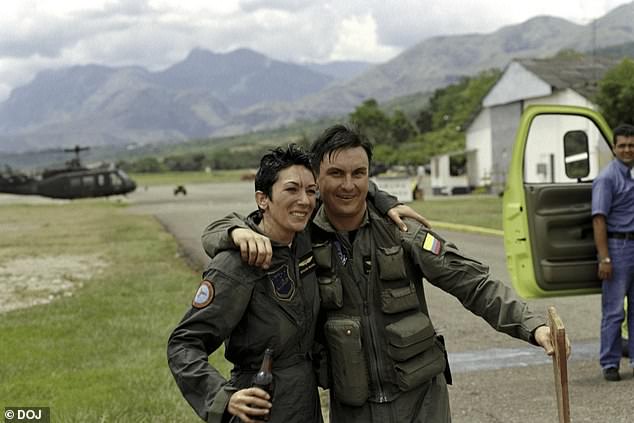 Ghislaine Maxwell wears a green jumpsuit as she poses with a man wearing military uniform bearing the flag of Colombia
