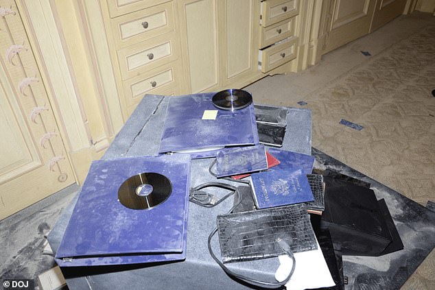 Dusty files, CDs and passports are pictured in Epstein's New York home