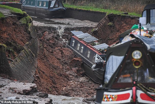 Pictures show the damage caused to one of the boats which has been left in the pit of the sinkhole