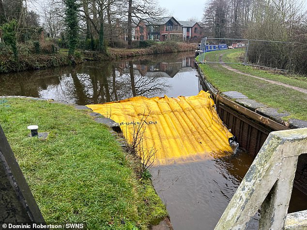 A water gate installed not long after the disaster which is preventing further water flooding into the field below the sinkhole