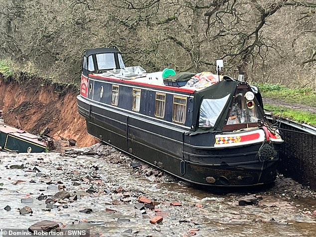 One boat can be seen teetering perilously close to the edge of the sinkhole