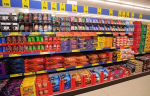 Lidl supermarket shelves stocked with chocolate bars and biscuits.