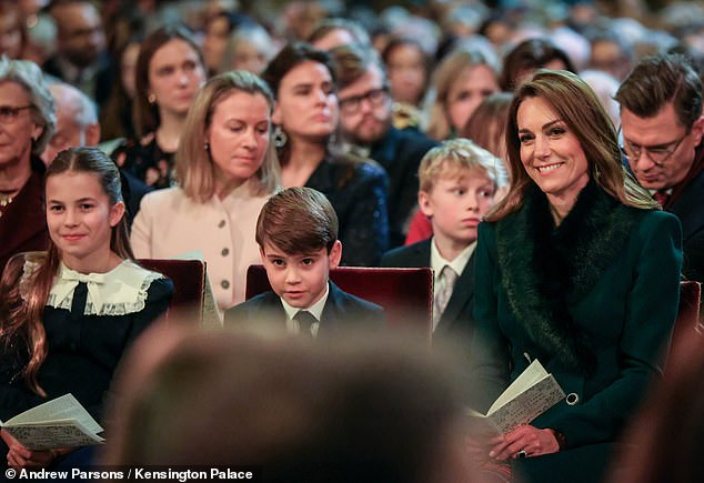 Kate sat next to her children - sporting an emerald winter coat - at the carol service