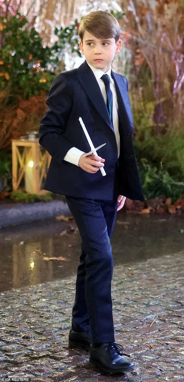 Prince Louis was smart in a navy suit for the occasion, holding onto a candle from the service as he exited