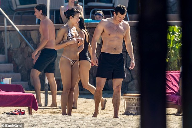 Callum went shirtless for the day out and showed off his hunky physique in a pair of dark swimming shorts